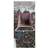 Small metal yard cart has holes in bottom