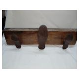 Coat rack made from wood and antique shoe forms