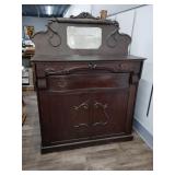 Antique Murphy bed with ornate features and
