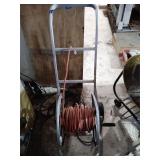 Extension cord on hose reel cart