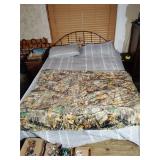 Queen size bed frame with mattress and bedding