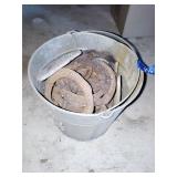 Galvanized bucket of horseshoes