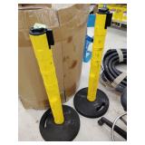 2 Beltrac ribbon tape barriers on stands 39' tall