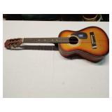 Harmony acoustic guitar has broken string