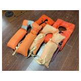Assorted Life Jackets and Seat Cushion