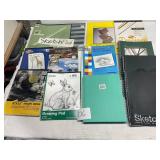lot of sketch pads and drawing papers