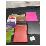 lot of clip boards and binders