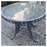 Round Glass Top Patio Table with Ornate Iron Frame