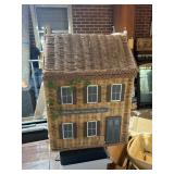 Wicker laundry basket shaped like a house