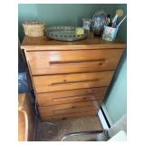A four drawer dresser nothing on dresser,