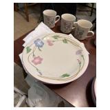 A plate set with cub bowls, and saucers
