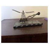 a vintage metal sculpture of a helicopter