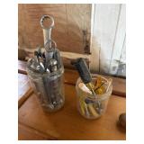Two jars of wrenches of screwdrivers