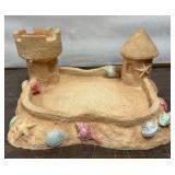 Sand castle display sea shells