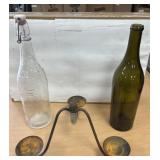 Candle holder with two wine bottles