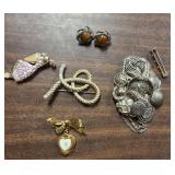 4 costume pins and 1 pair of clip on earrings