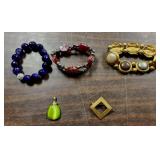 3 bracelets, 1 charm and 1 pin all costume