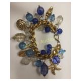 gold tone charm bracelet w/ blue & clear beads tar