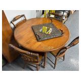 Five piece round oak dining table with leaf design