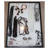 #63 Lot of assorted jewelry in glass case