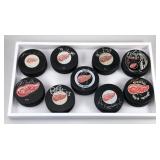 #597 Lot of 9 Detroit Red Wings Signed Pucks 