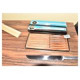 KNIFE SET AND A VINTAGE ICE CRAKER