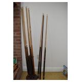8 CUE STICKS W/ RACK -VIPOR, LUCKY ETC.