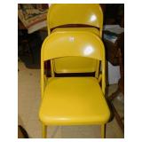 TWO YELLOW METAL FOLDING CHAIRS