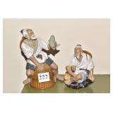 TWO ORIENTAL MUD MEN ONE MISSING POLE