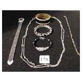 FIVE COSTUME JEWELRY BRACELETS, ONE SILVER TONE