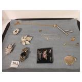 NECKLACE WITH A PEN ON THE END, PINS, ETC.