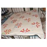 66" X 80" RED/ GREEN FLOWER QUILT WITH TEAR AND