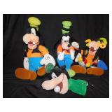 GOOFY STUFFED ANIMAL AND PUPPET IN FRONT .