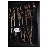 7 GOLD TONE ASSORTED NECKLACES W/ VELVET HOLDER