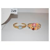 TWO CUFF BRACELETS ONE W/ FLOWERS AND LADY BUG