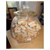 COLLECTION OF WINE CORKS IN PLANTER PEANUT JAR