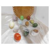 BASKET OF HOLLOW CERAMIC EGGS, STONE AND WOOD