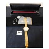 AUGUST STEINER GOLD TONE WRISTWATCH AND RED