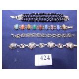 FOUR BRACELETS SILVER TONE, POLISHED STONE SCARAB