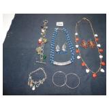 TWO CHARM BRACELETS, BLUE BEADED NECKLACE AND