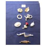 GROUP OF NINE PINS BROOCHES SILVER TONE AND GOLD