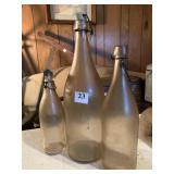 THREE GLASS BOTTLES W/ CAPS