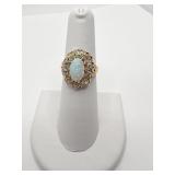 OPAL RING IN GOLD SETTING WITH 10 DIAMONDS AROUND