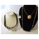 LARGE SILVER TONE FOCAL PIECE ON MULTI STRAND