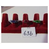 THREE SILVER TONE RINGS BLUE RED AND GREEN STONES