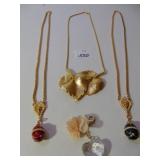 TWO GOLD TONE CHAIN NECKLACES WITH EGG PENDANTS
