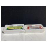 TWO TROLLEY CARS IN SHRINK WRAP