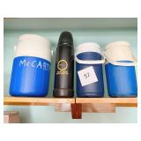 3 COLEMAN DRINK PITCHERS, ONE STEEL DRINK HOLDER,