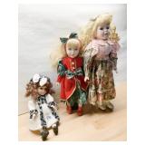THREE REPRODUCTION PORCELAIN DOLLS