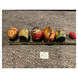 6 WOODEN EGGS, 1 CARVED, ONE WITH STRING AND